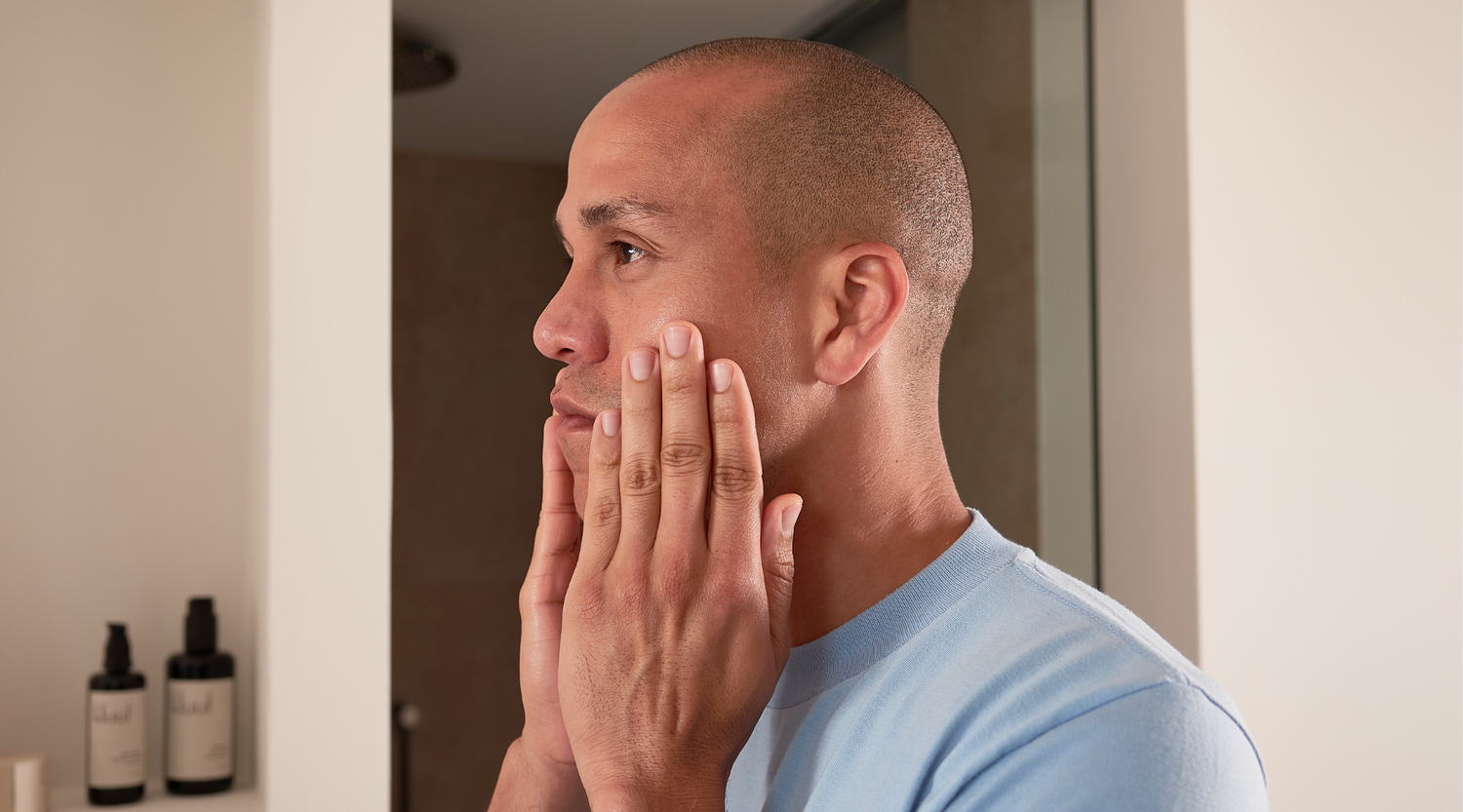 Male model cleaning his face with kluuf's gentle facial cleanser